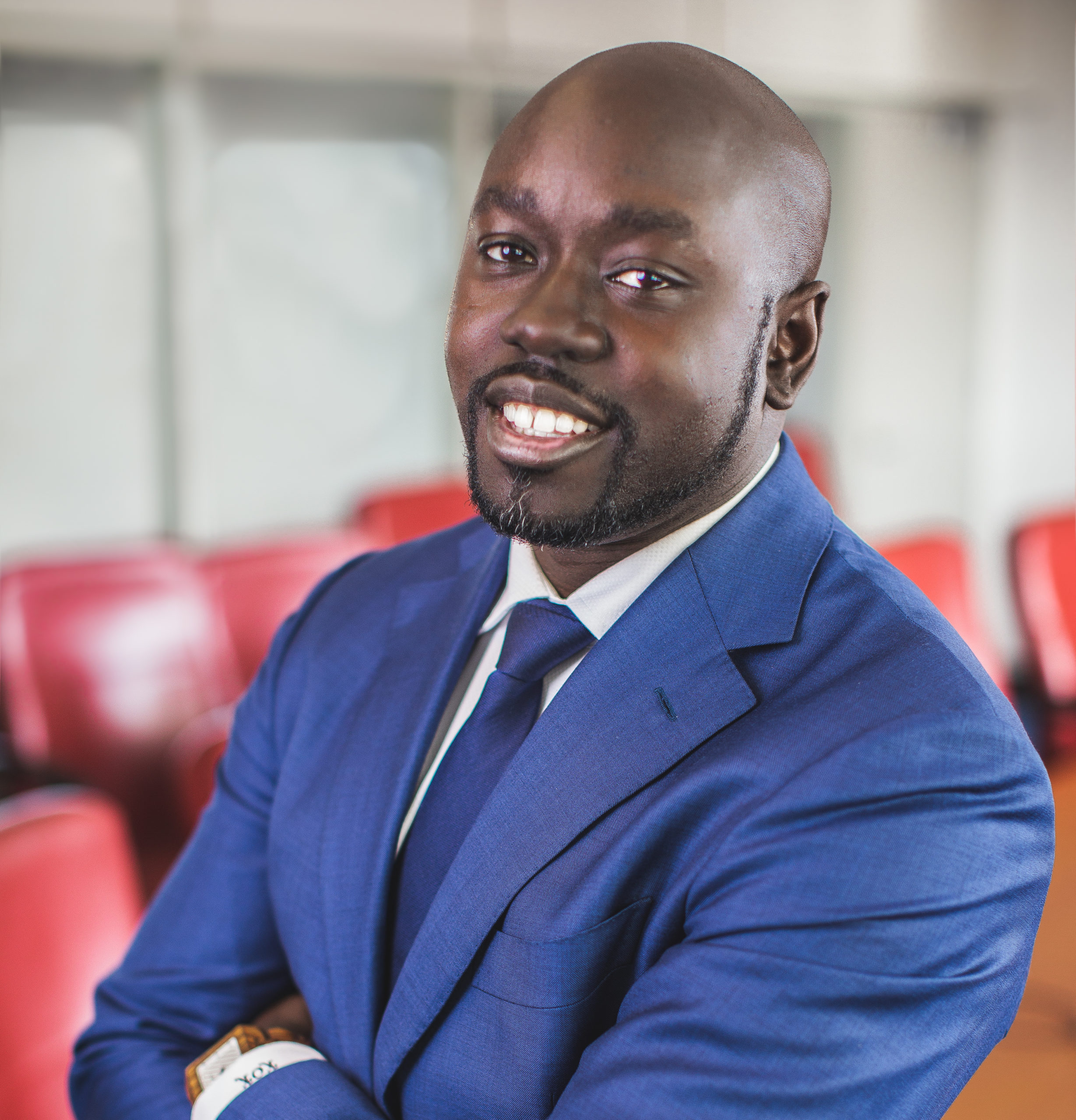 Kwame Owusu-Kesse | Man posing and smiling at the camera.