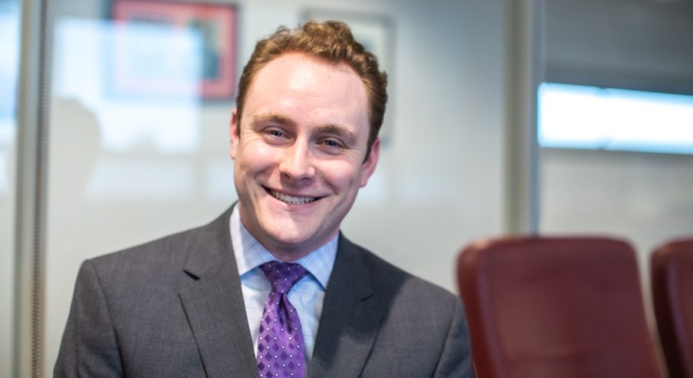 Man in grey suite and purple tie