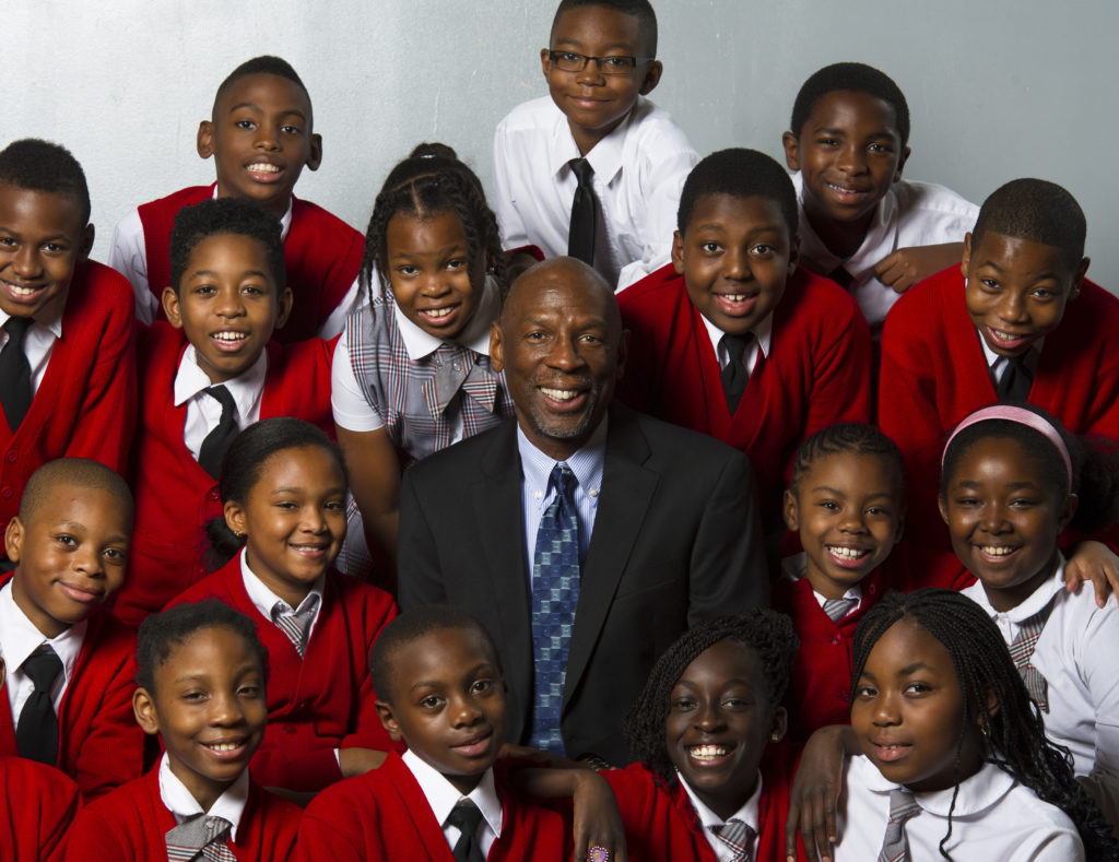 Geoffrey Canada and children smile at the camera