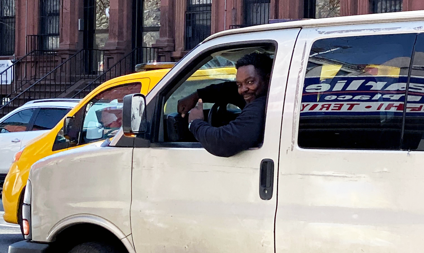 Man smiling in a van.