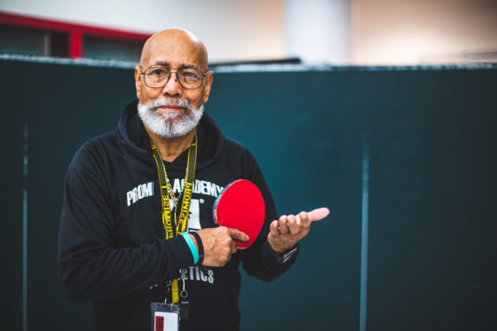 After School Athletics Specialist Donald Redd plays ping pong with his scholars.