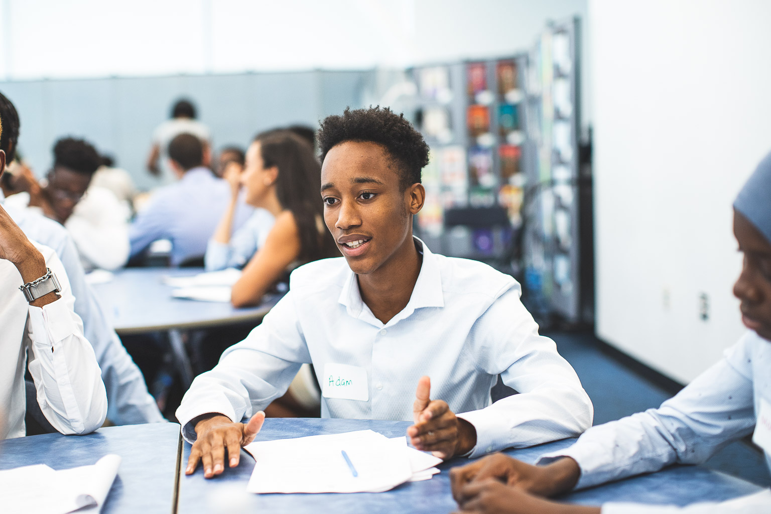HCZ Promise Academy scholar in white shirt giving a presentation during an event hosted by Center for Higher Education and Career Support.