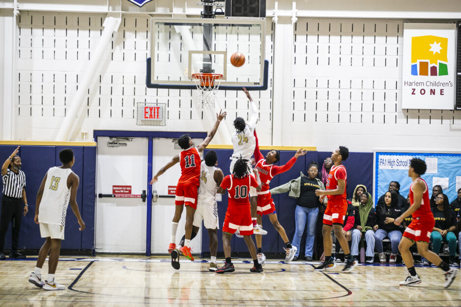 Scholars playing basketball in the gym.