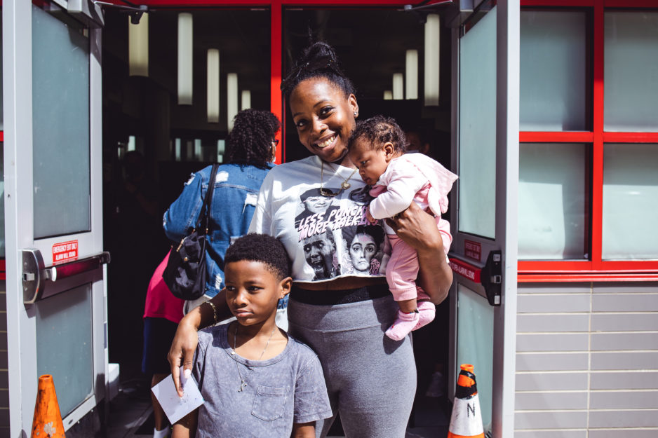 Harlem Children's Zone community member holds baby