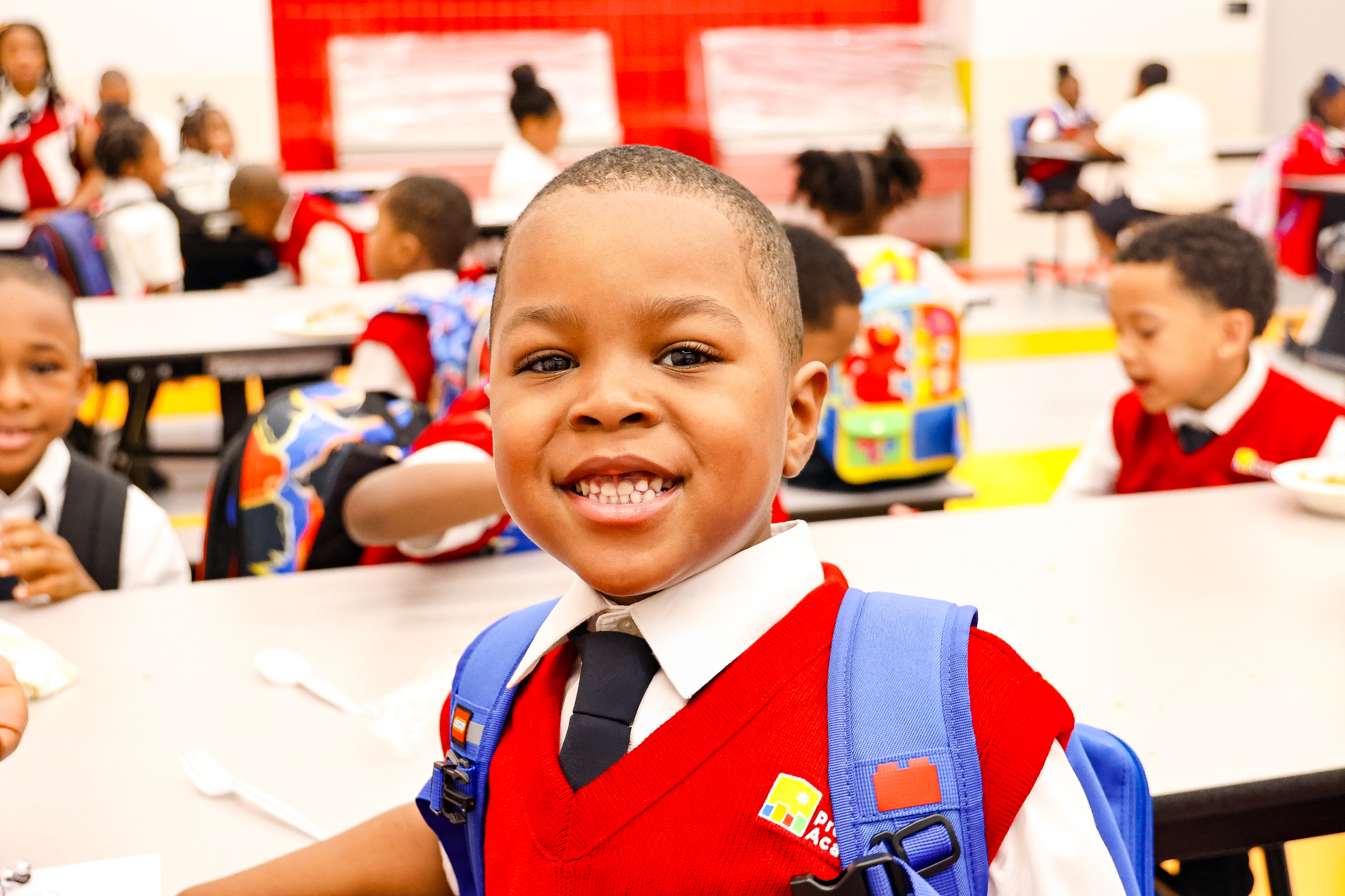 Young male scholar smiles at the camera