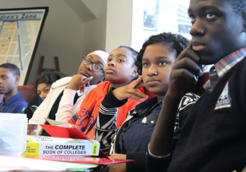 Harlem Children's Zone scholars sit at desk and learn how to apply to college