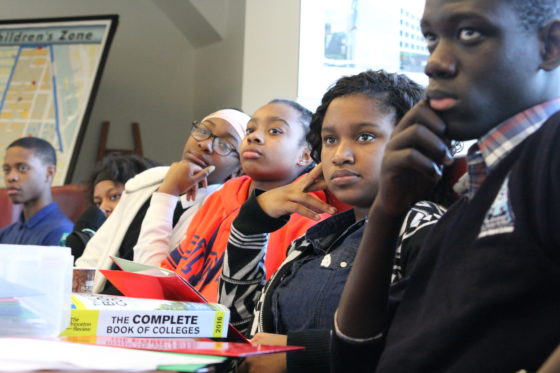 Harlem Children's Zone scholars sit at desk and learn how to apply to college