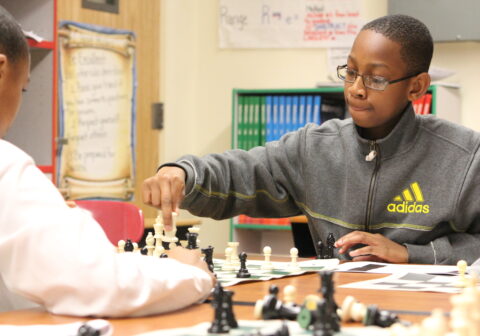 Two students play chess.