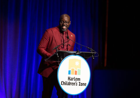 Harlem Children's Zone CEO Kwame Owusu-Kesse standing at lectern at Friend of the Children Award Dinner.