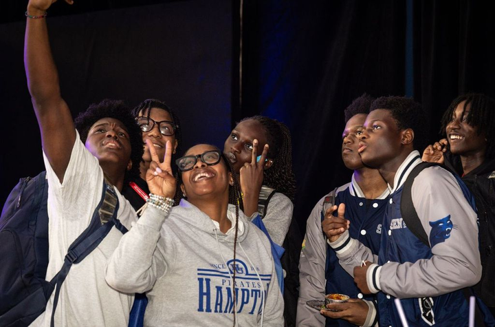 Young people look at camera.