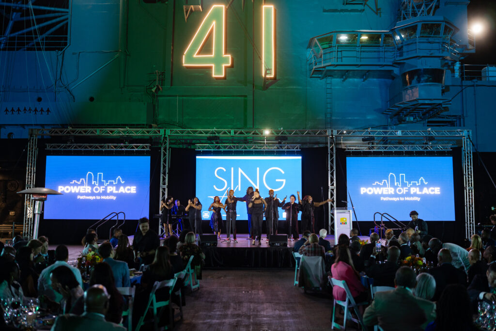 A choir sings on a stage.