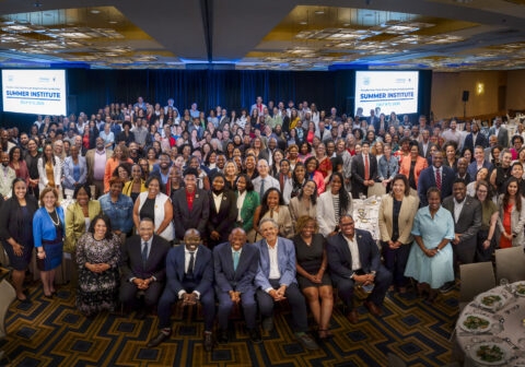 Group photo of smiling professionals dressed in business professional.