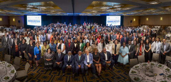 Group photo of smiling professionals dressed in business professional.