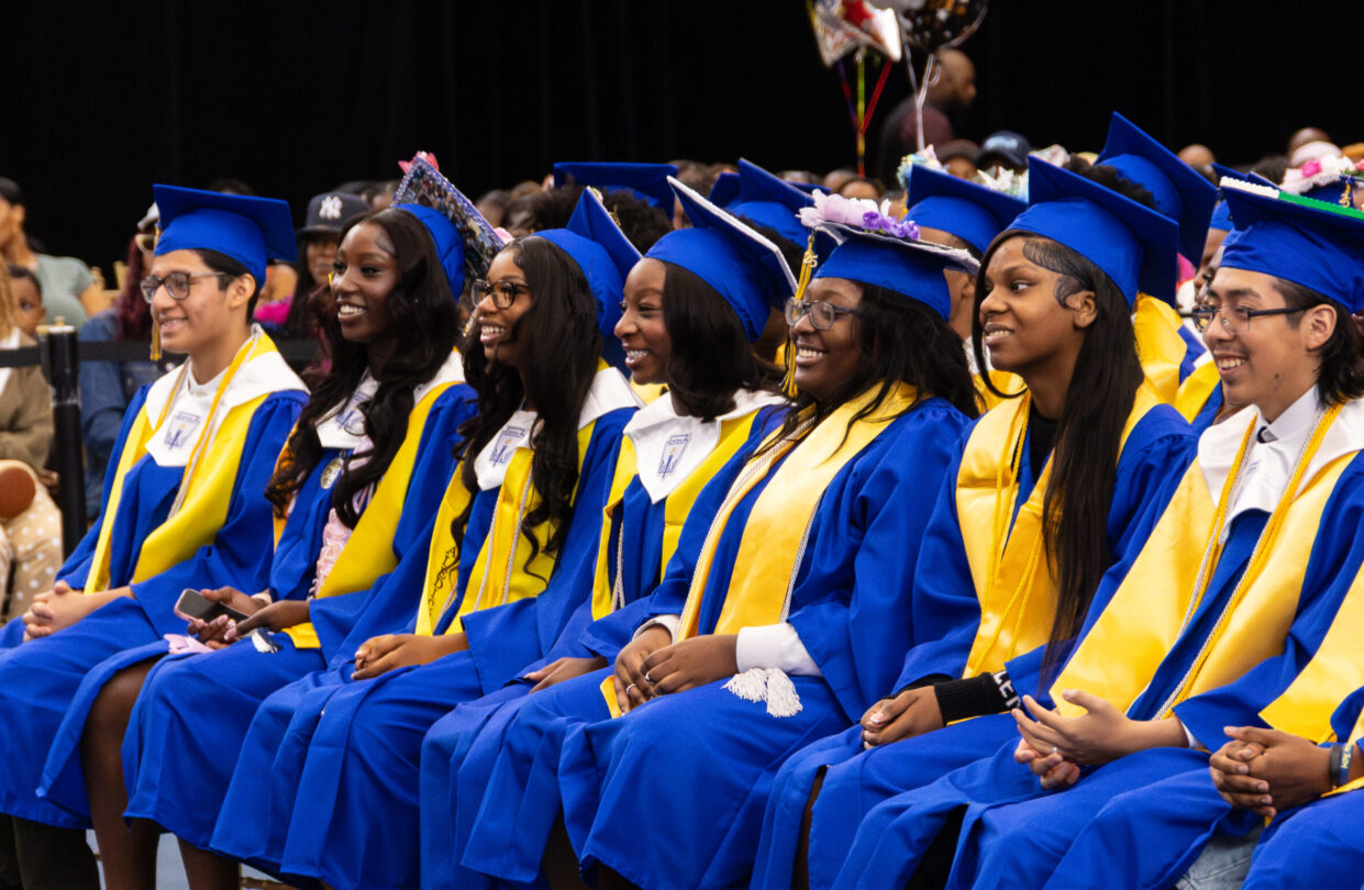 HCZ Promise Academy High School seniors sit and smile during graduation day at The Armory.