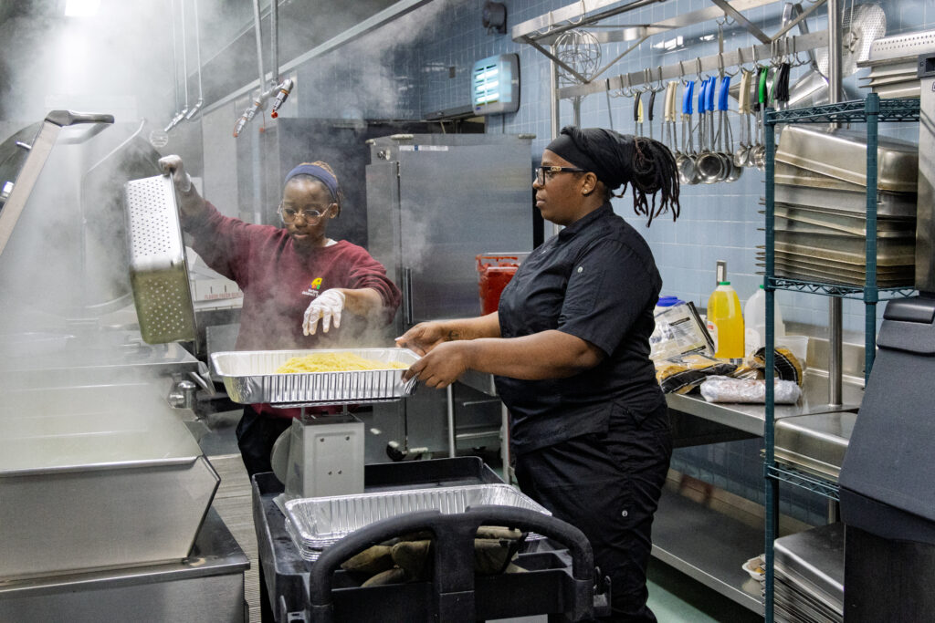 Two chefs cooking in the kitchen.