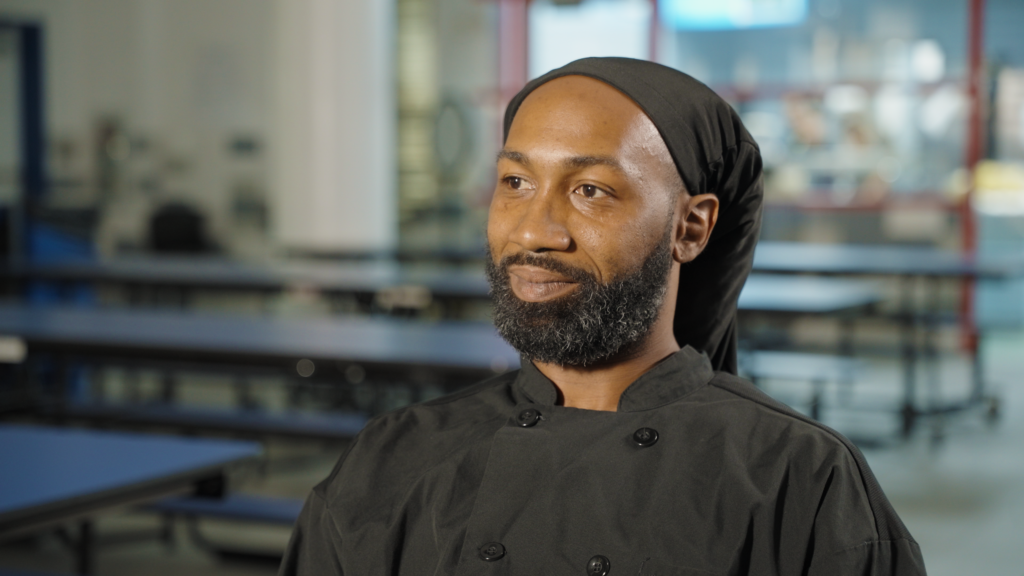 Male chef sitting looking off in the distnce