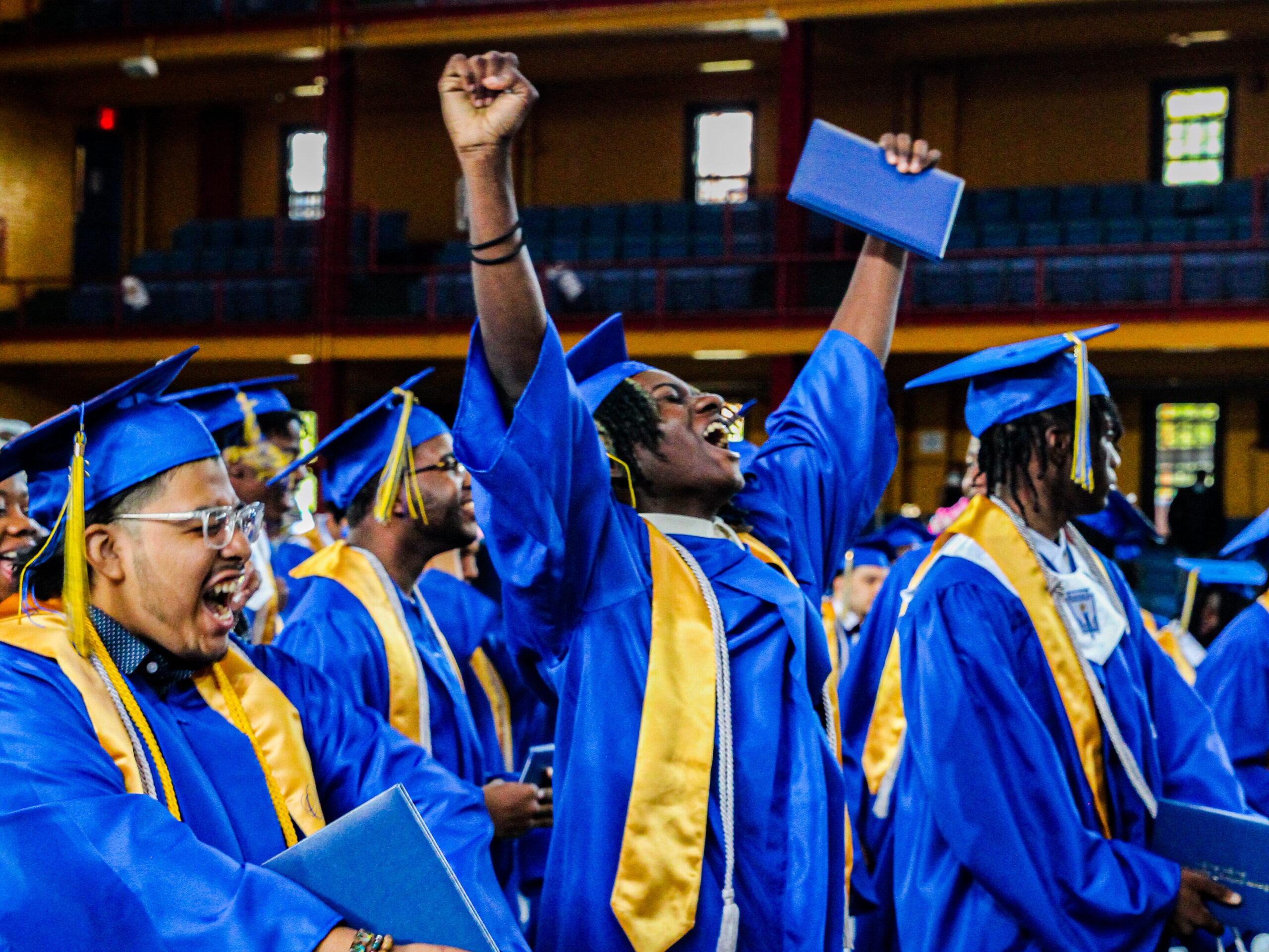 graduating scholars celebrating at their graduation ceremony.