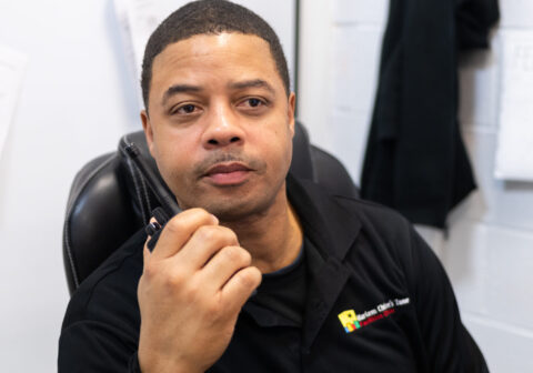 man speaking into a walkie