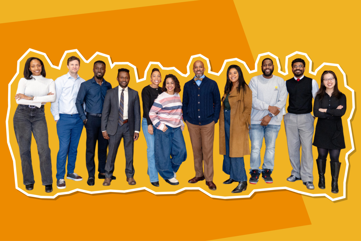 Group image of smiling workers dressed in business professional, with an orange background.
