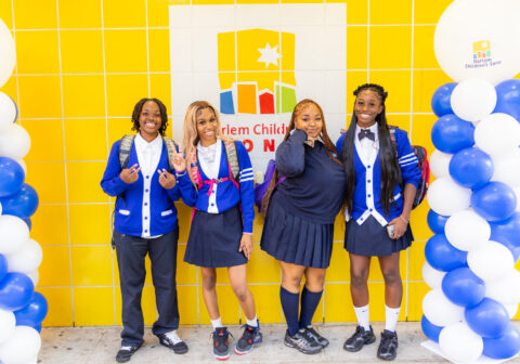 students in uniform standing outside of promise academy