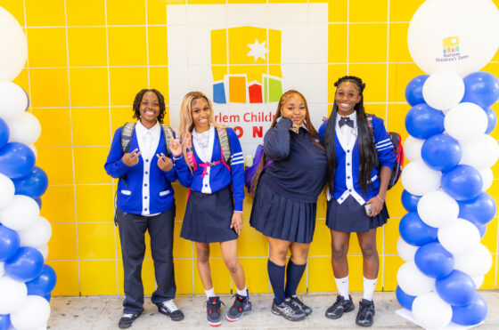 students in uniform standing outside of promise academy