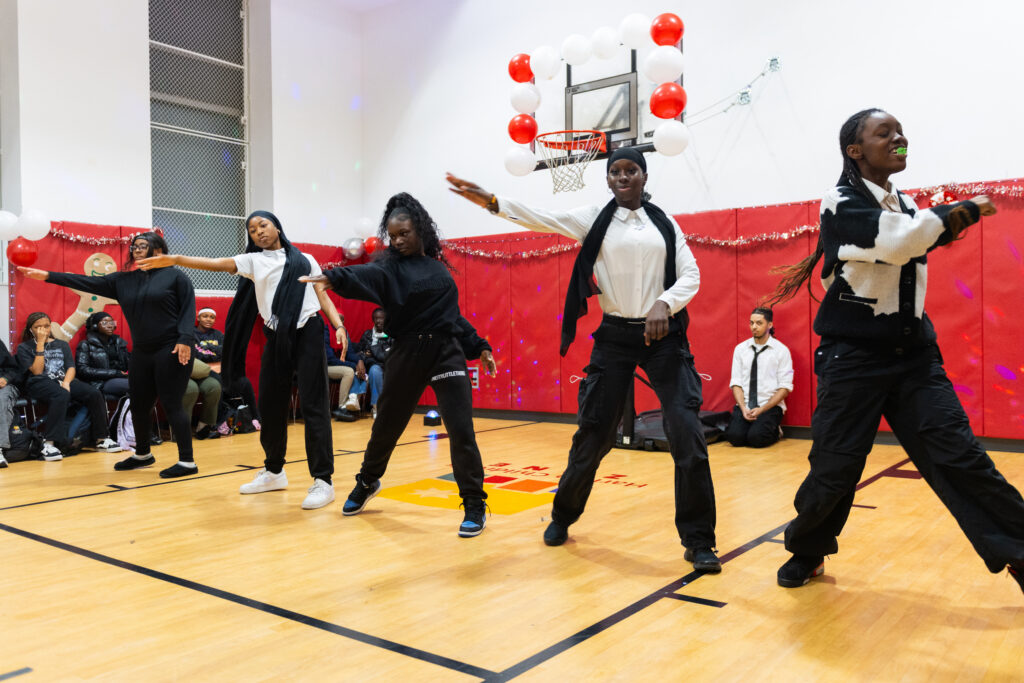 Scholars in the gym practicing dance